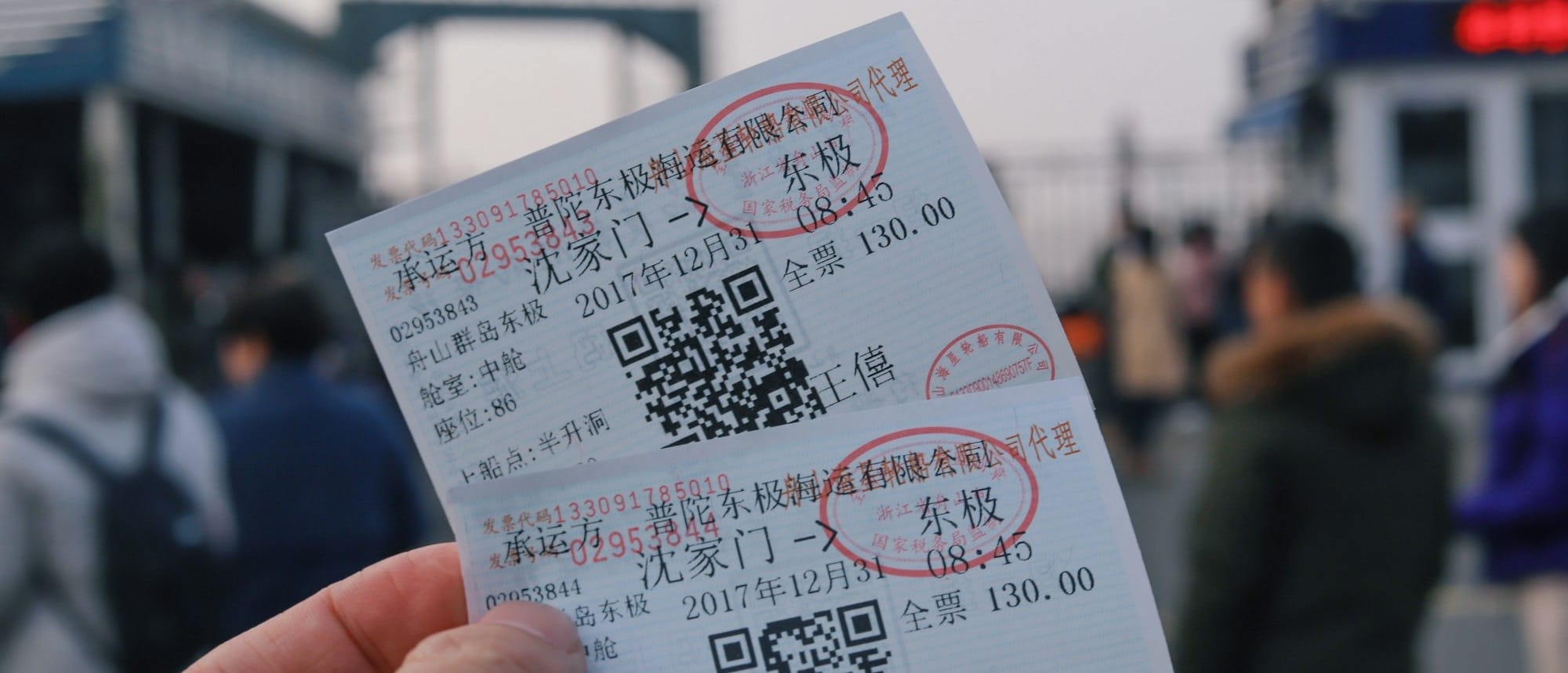 person holding two white tickets