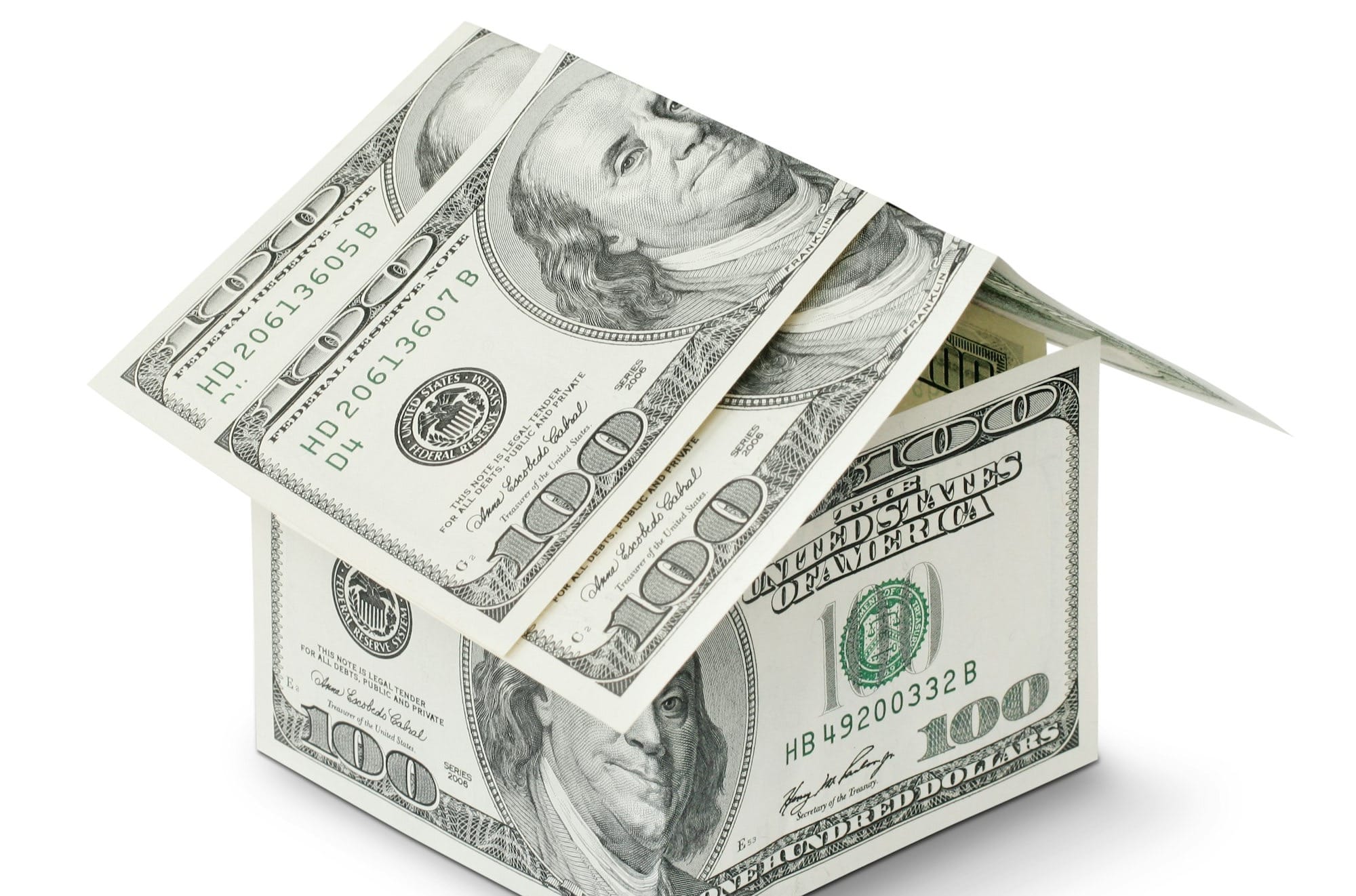 a house made out of money on a white background