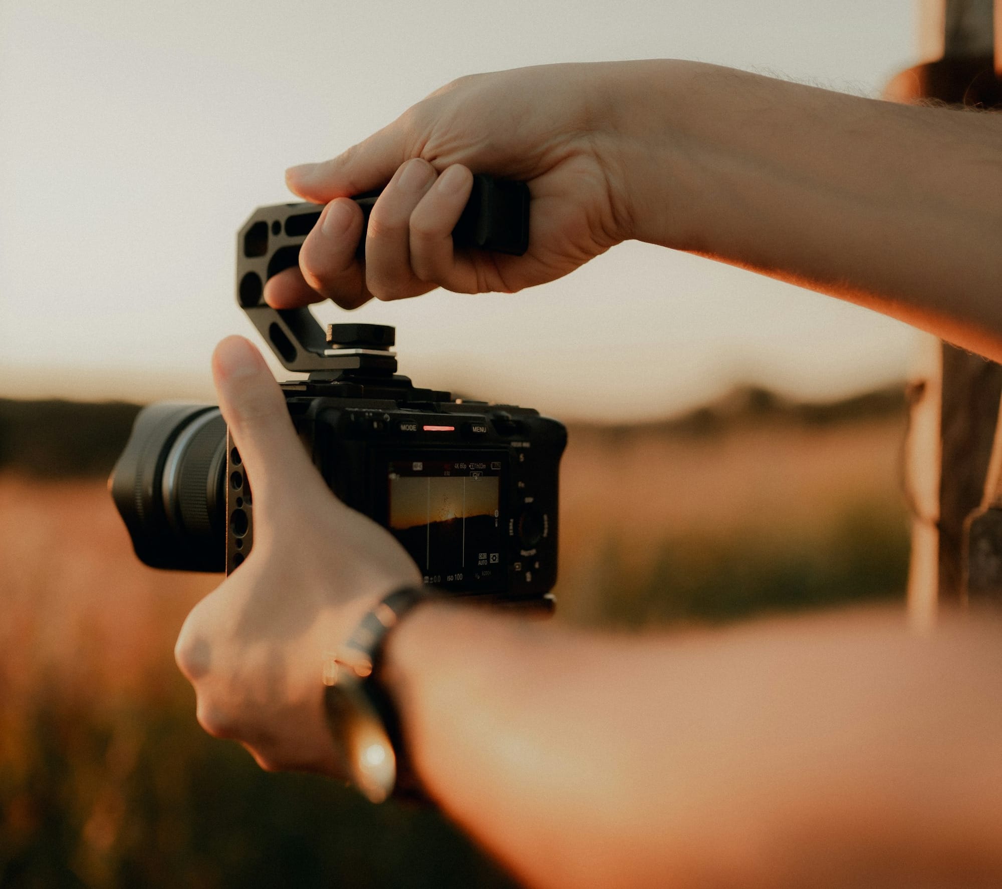 Hands holding a camera with a handle